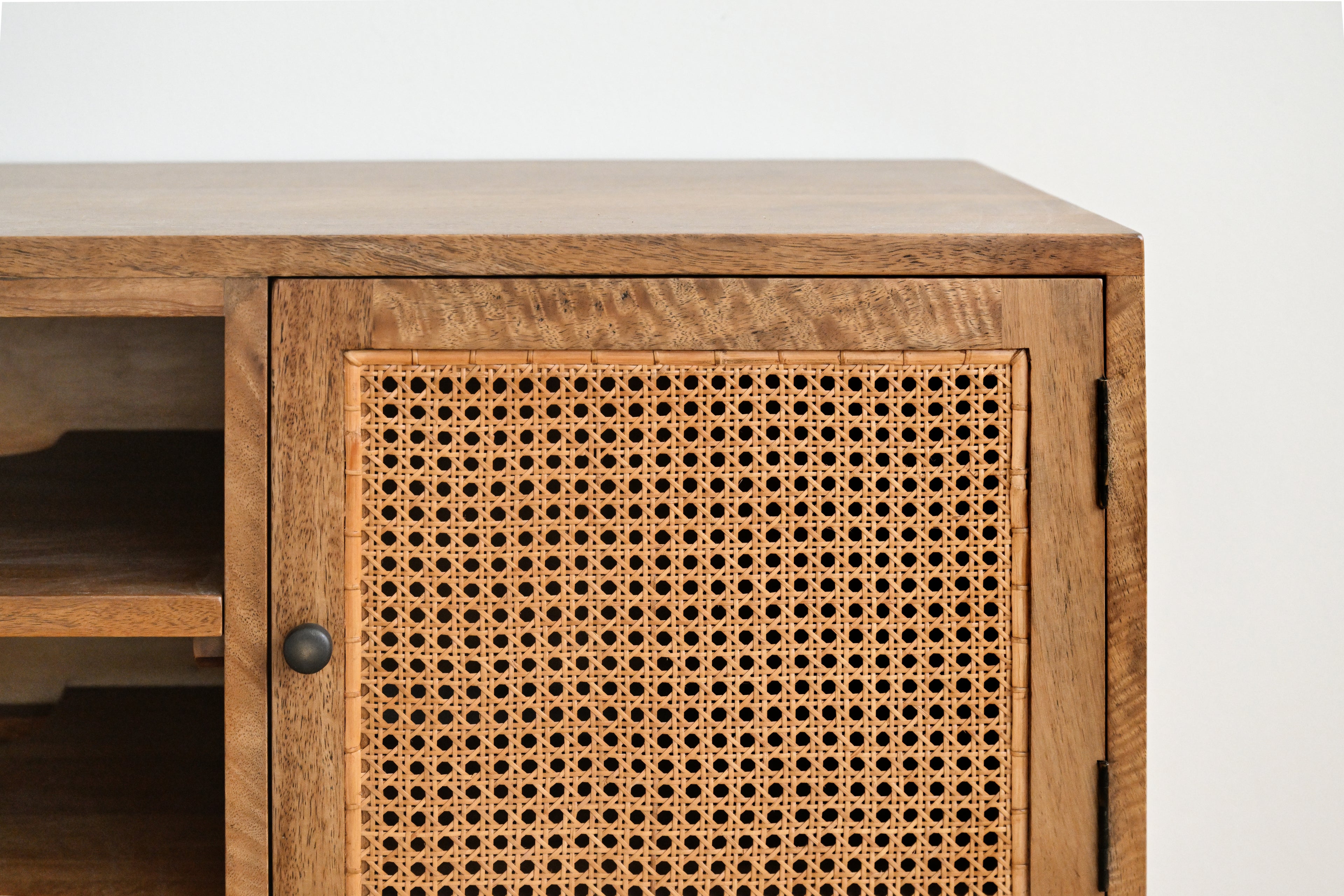 Wooden cabinet with wicker door on a white background