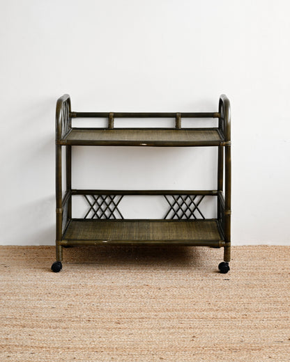 Vintage-style metal serving cart on a beige carpet with a white wall background