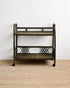 Vintage-style metal serving cart on a beige carpet with a white wall background