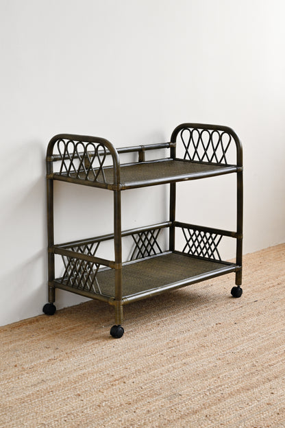 Metal serving cart with two shelves on a beige carpeted floor.