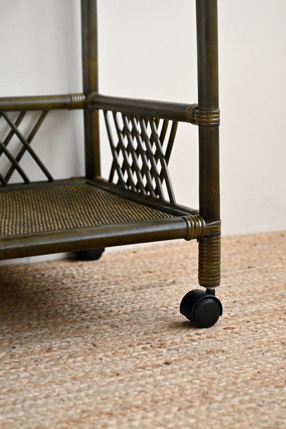 Metal cart with wheels on a textured surface