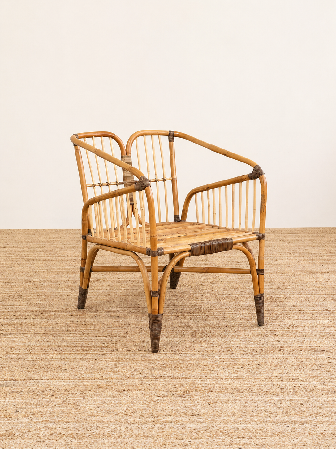 Wicker chair with black accents on a textured surface