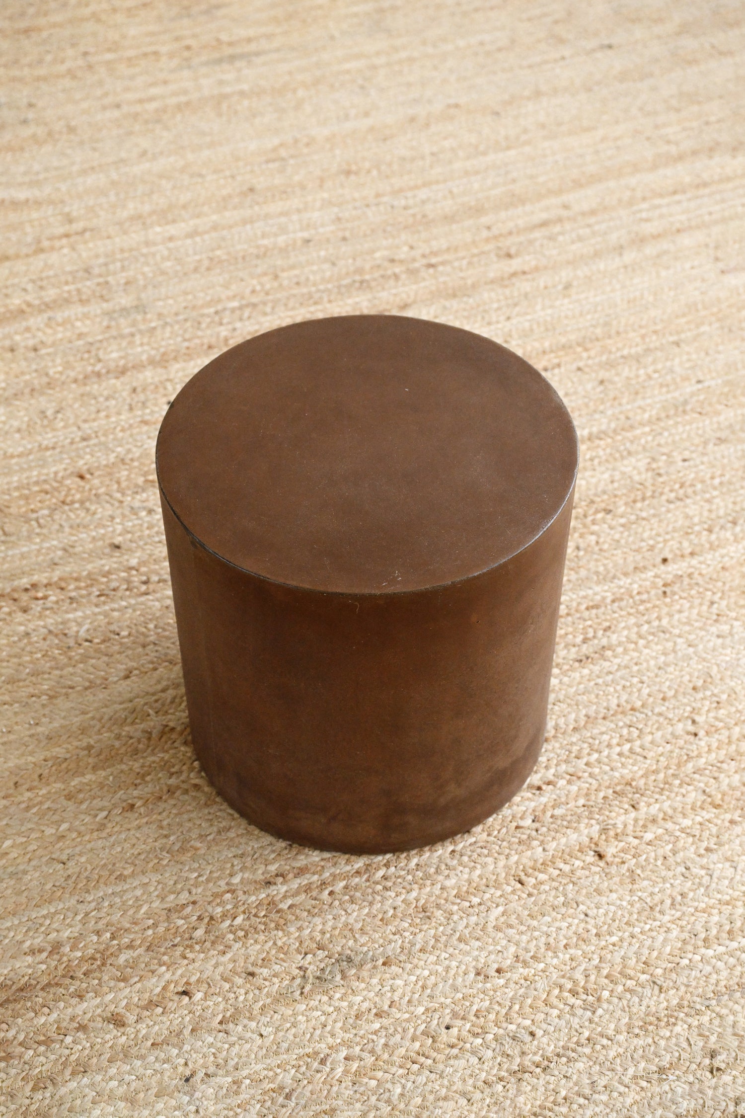 Brown cylindrical object on a textured beige surface