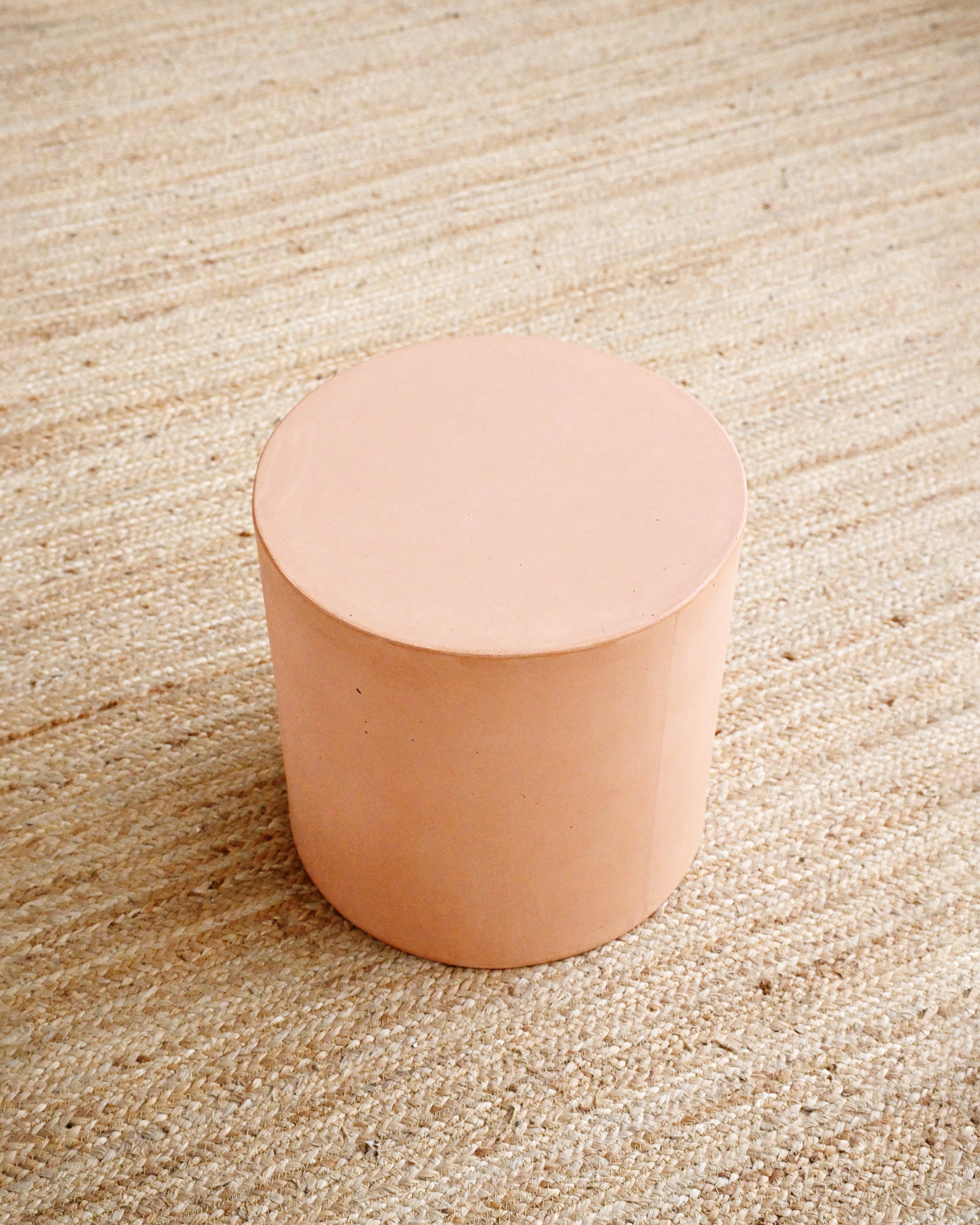 Round beige object on a textured beige surface