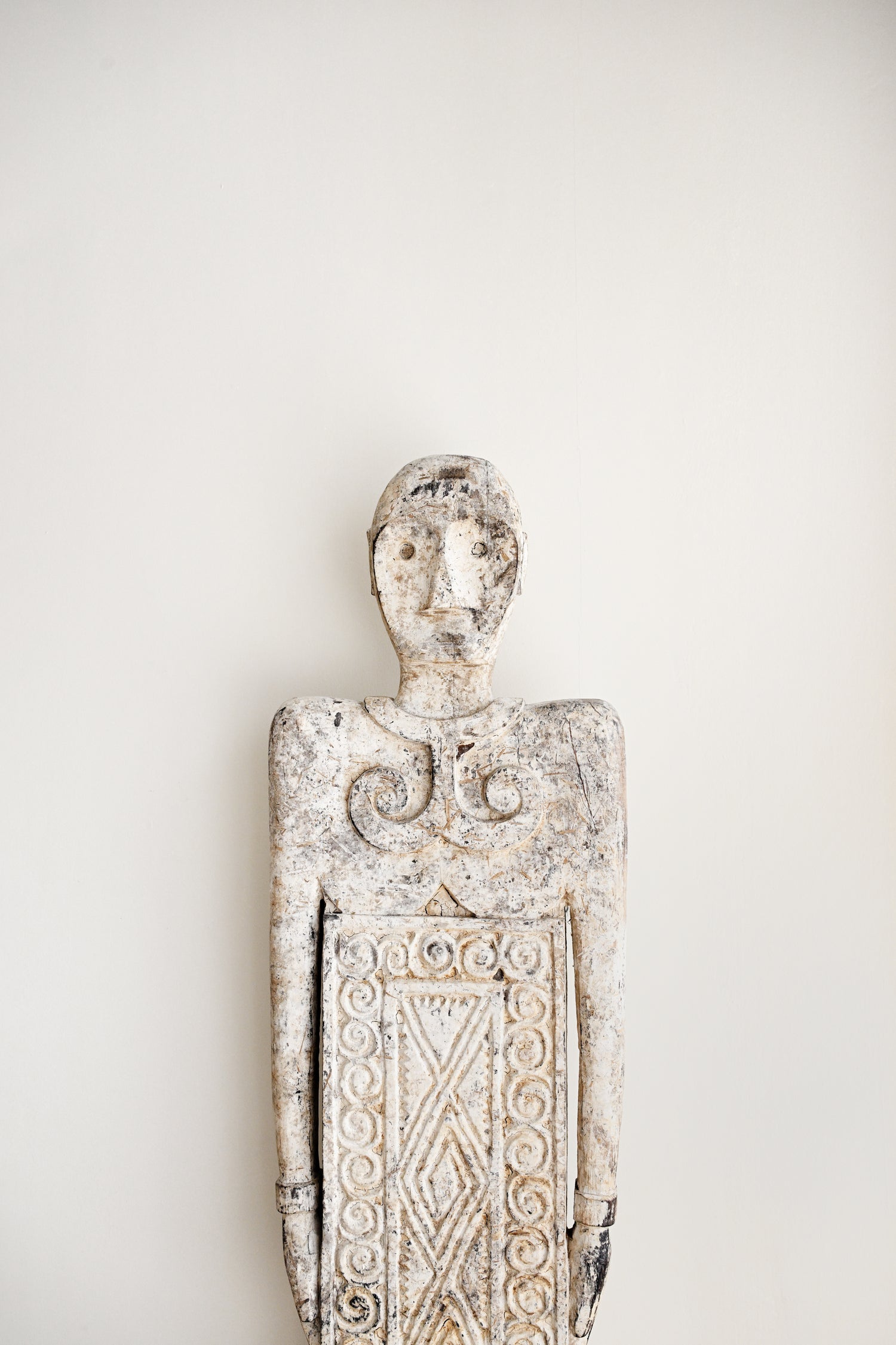 Decorative wall sculpture with intricate patterns on a plain background