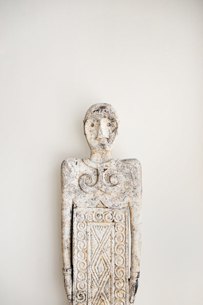 Decorative wall sculpture with intricate patterns on a plain background
