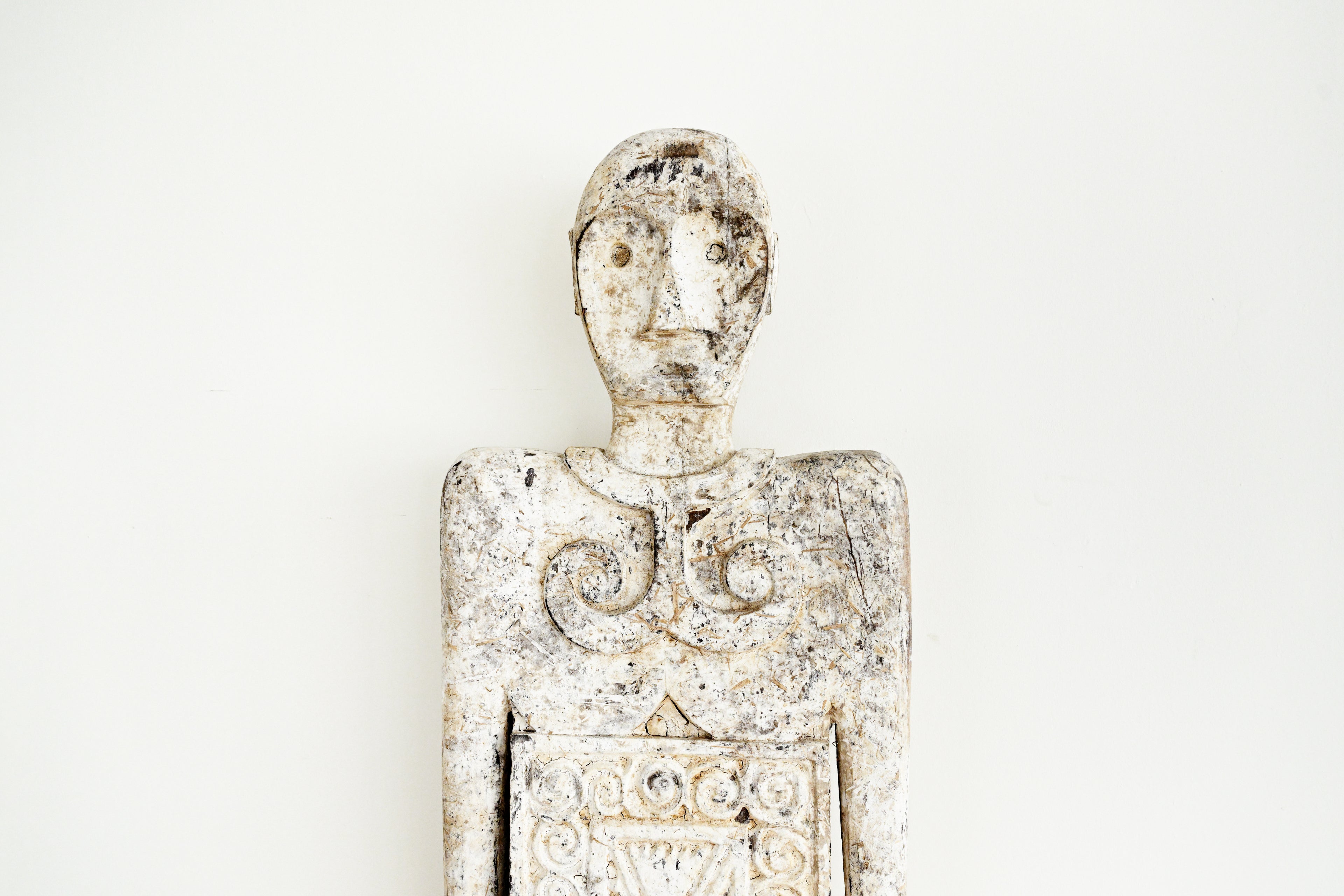 Decorative figurine with intricate details on a white background