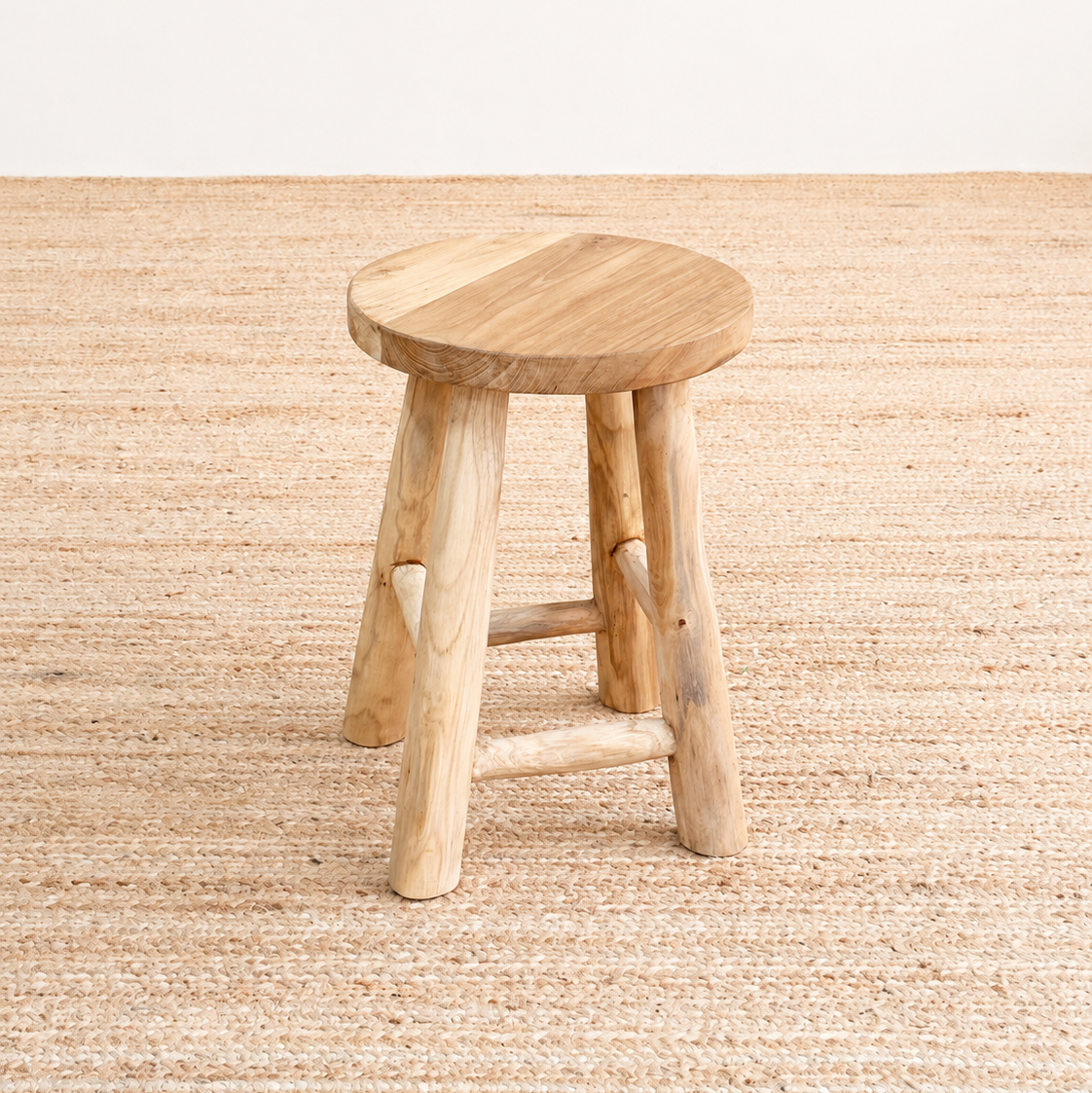 Wooden stool on a textured beige floor