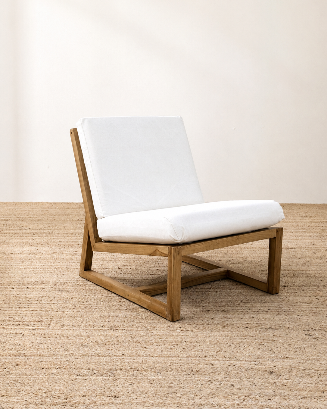 Wooden chair with white cushion on a wooden floor and white wall background