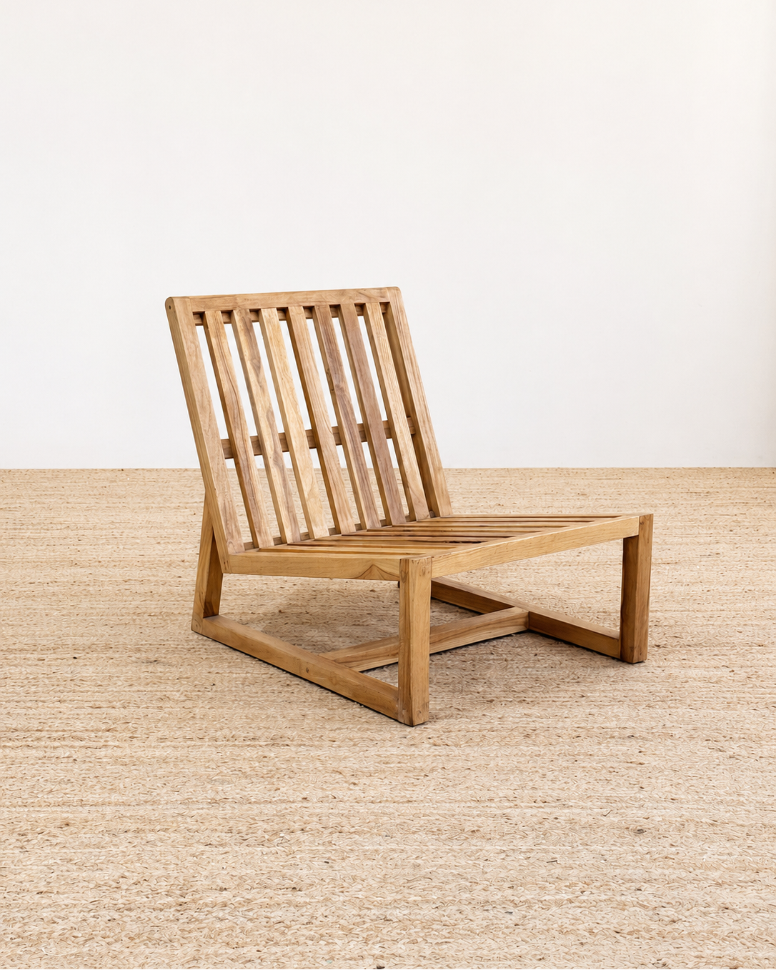 Wooden chair on a textured floor with a white wall background