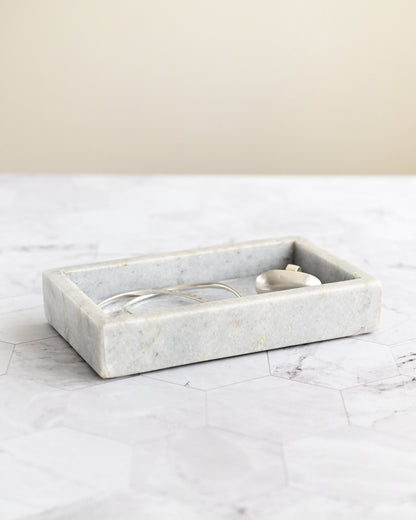 Marble tray on a marble surface with a neutral background