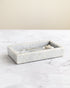 Marble tray on a marble surface with a neutral background