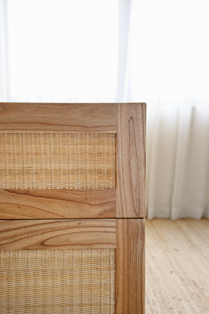 Wooden drawer with wicker pattern on a light wooden floor.