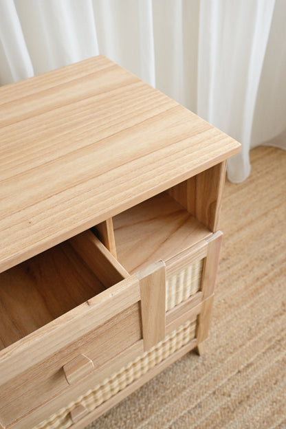 Wooden cabinet with a woven basket on a wooden floor