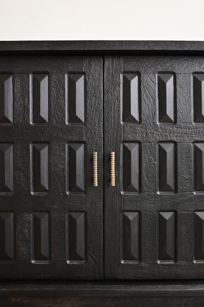 Black metal cabinet with textured surface and decorative handle on a white background