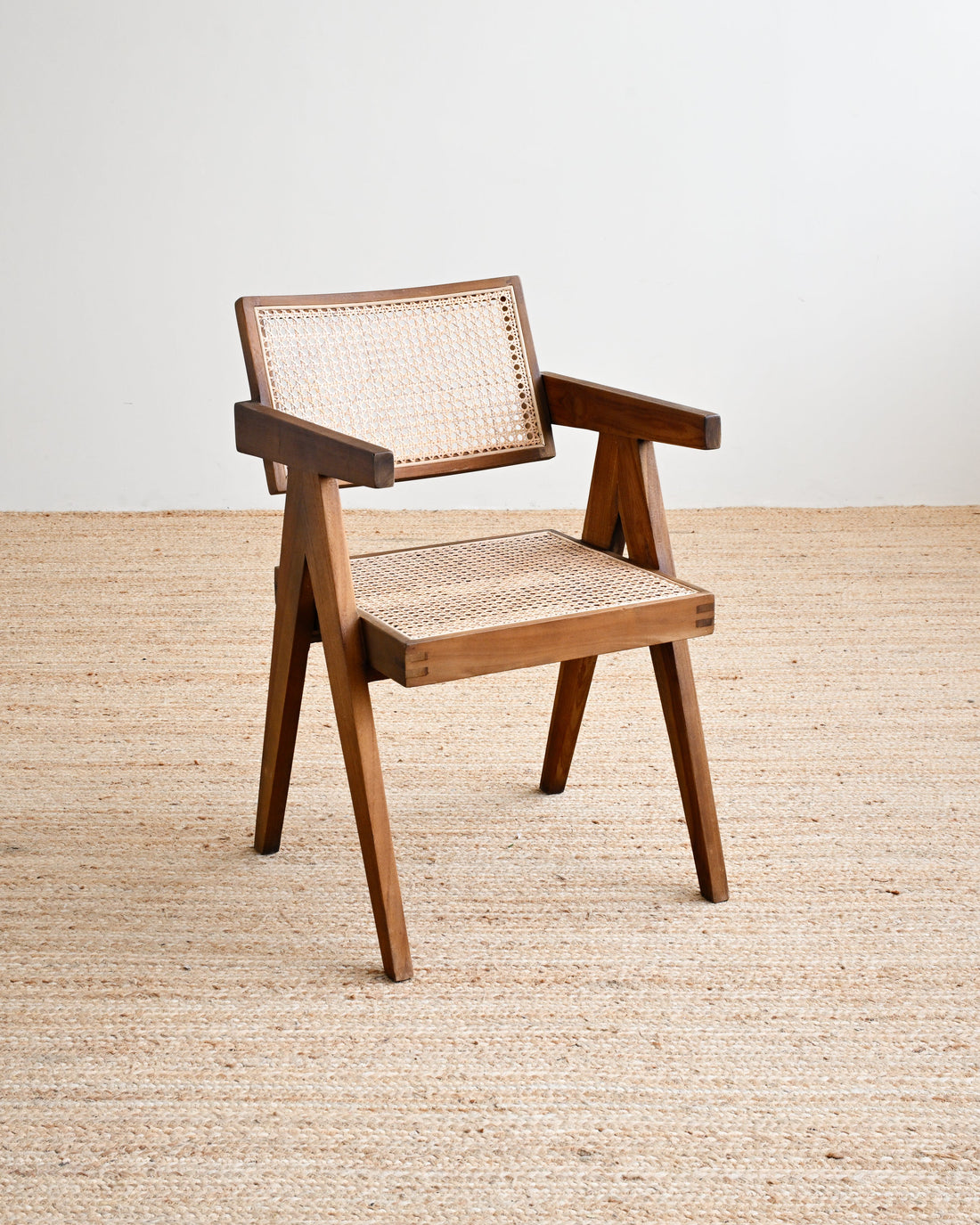 Wooden chair with woven seat and backrest on a beige carpet