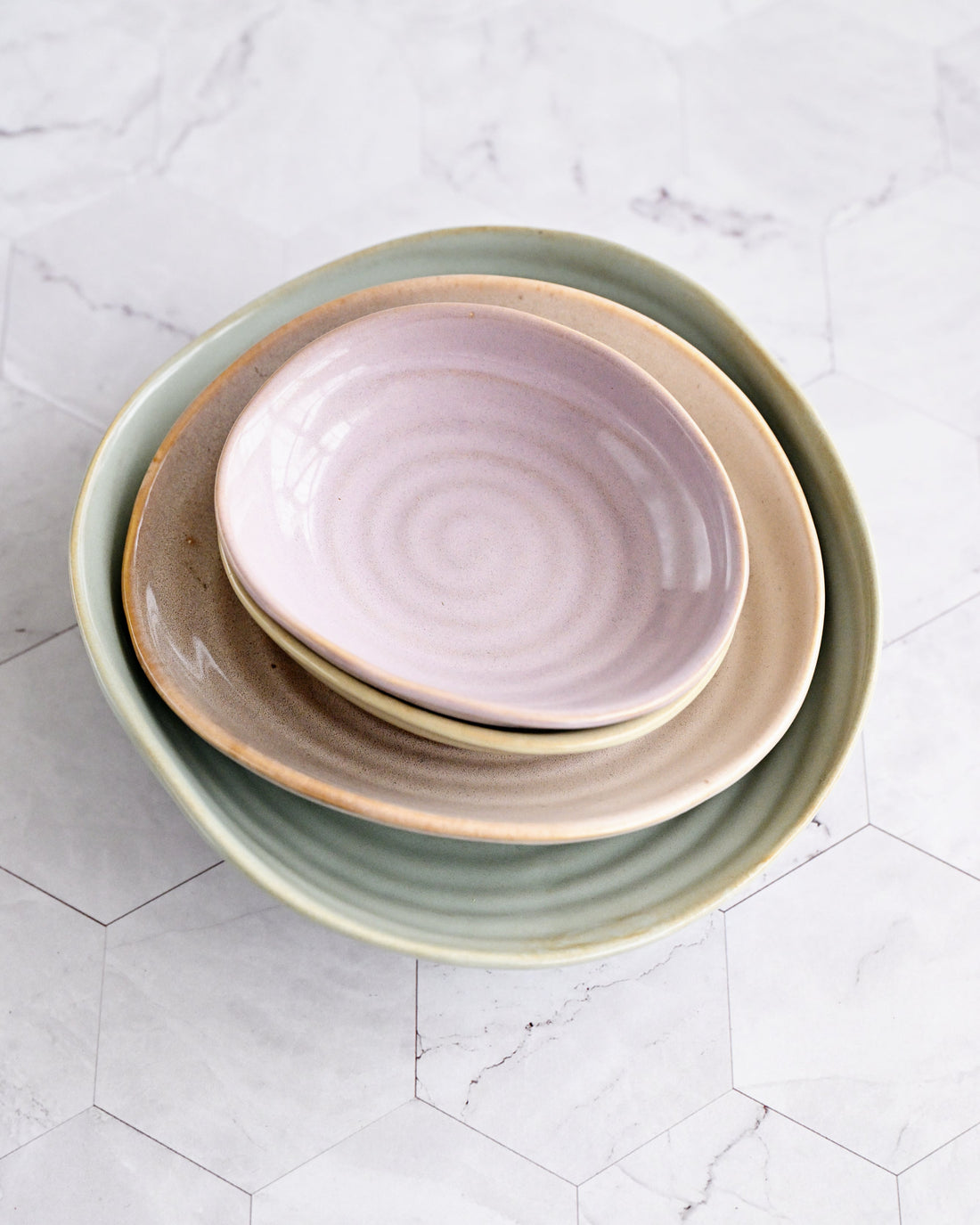 Stack of ceramic bowls on a light gray surface