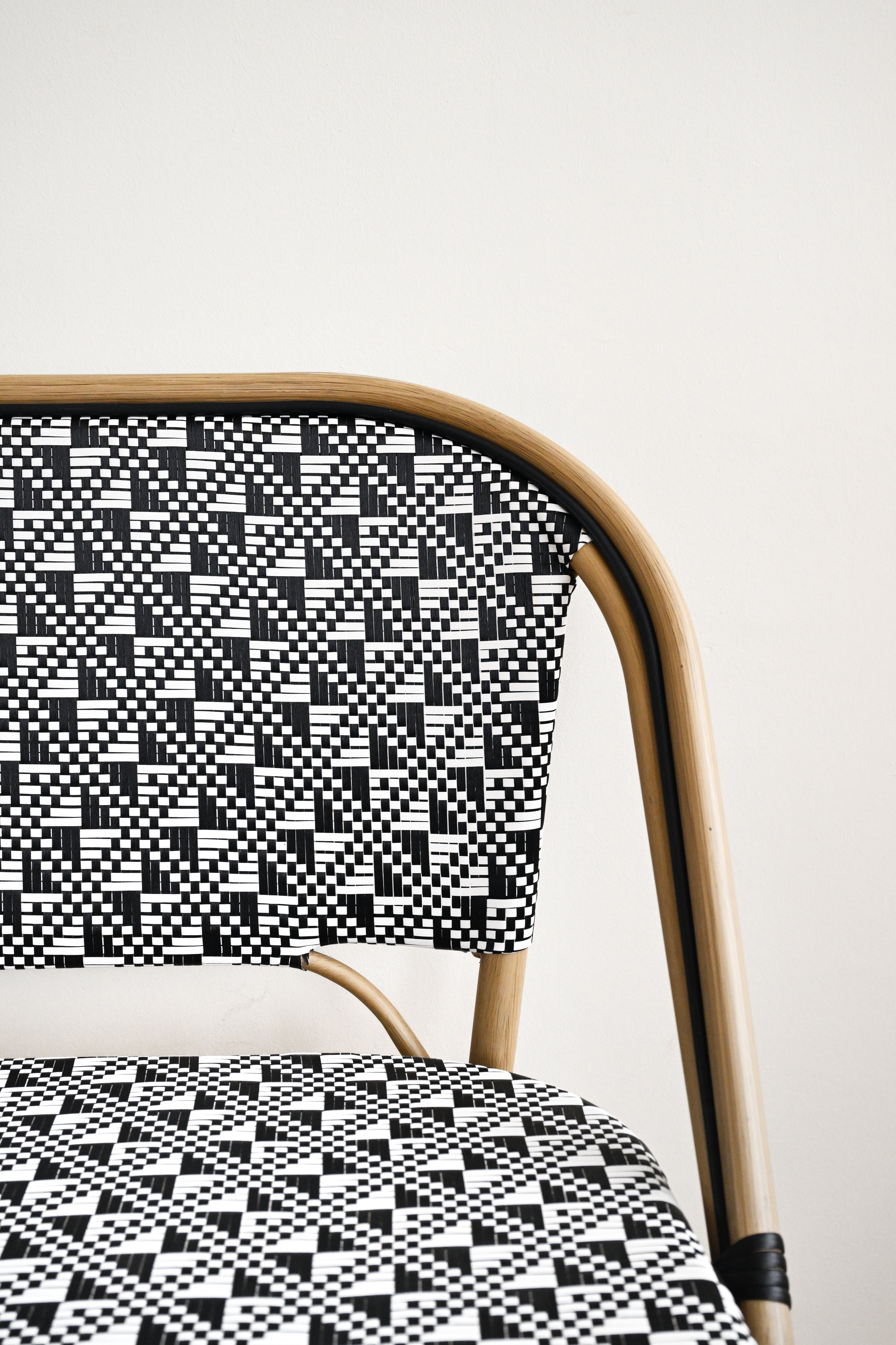 Chair with a black and white geometric pattern on a plain background
