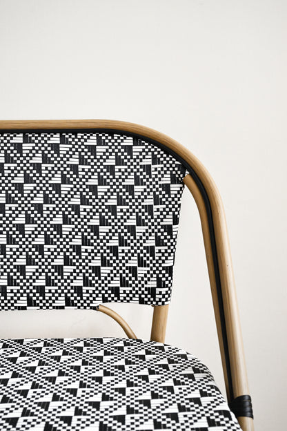 Chair with a black and white geometric pattern on a plain background