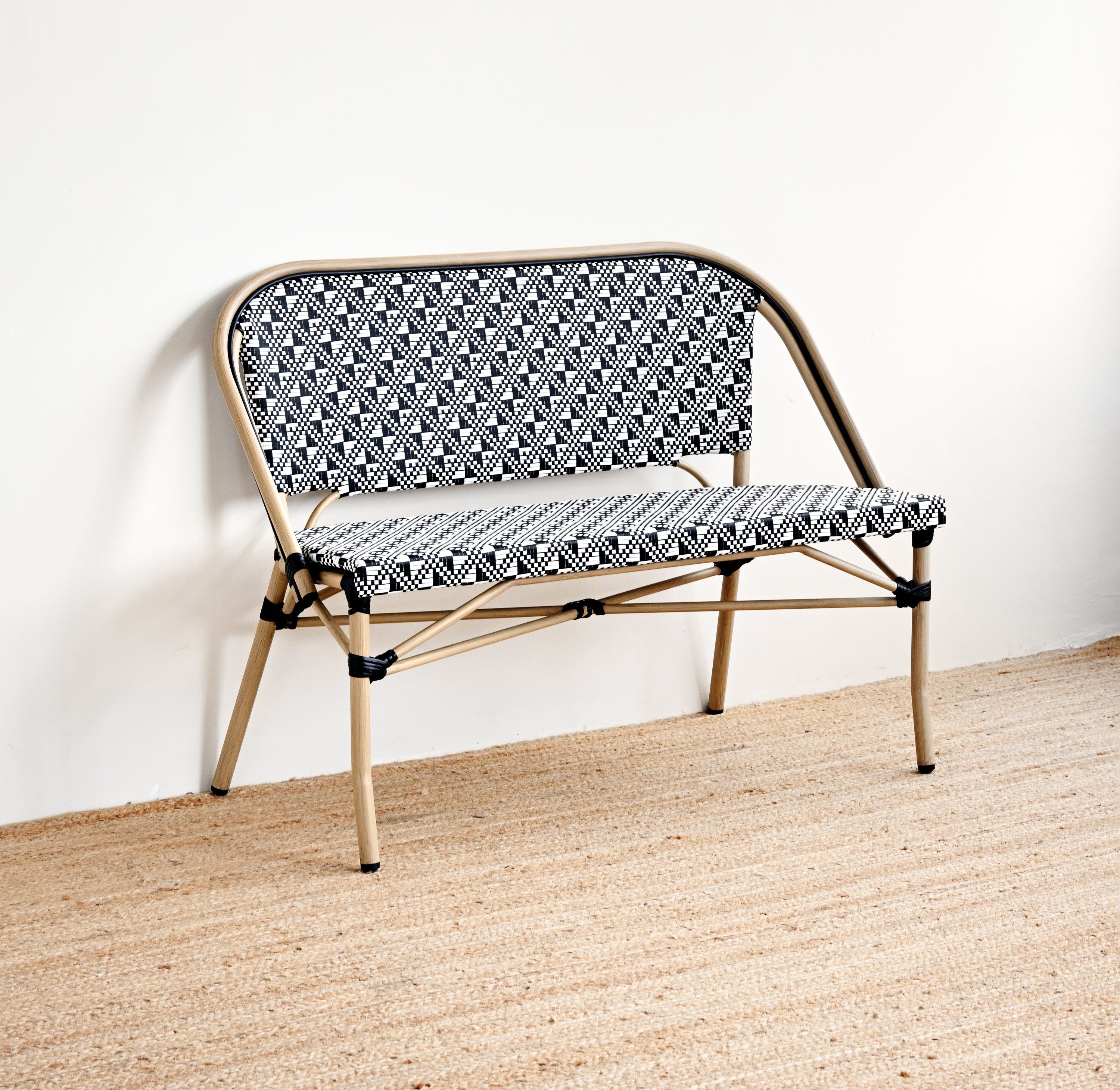 Foldable chair with patterned seat and backrest on a textured surface.