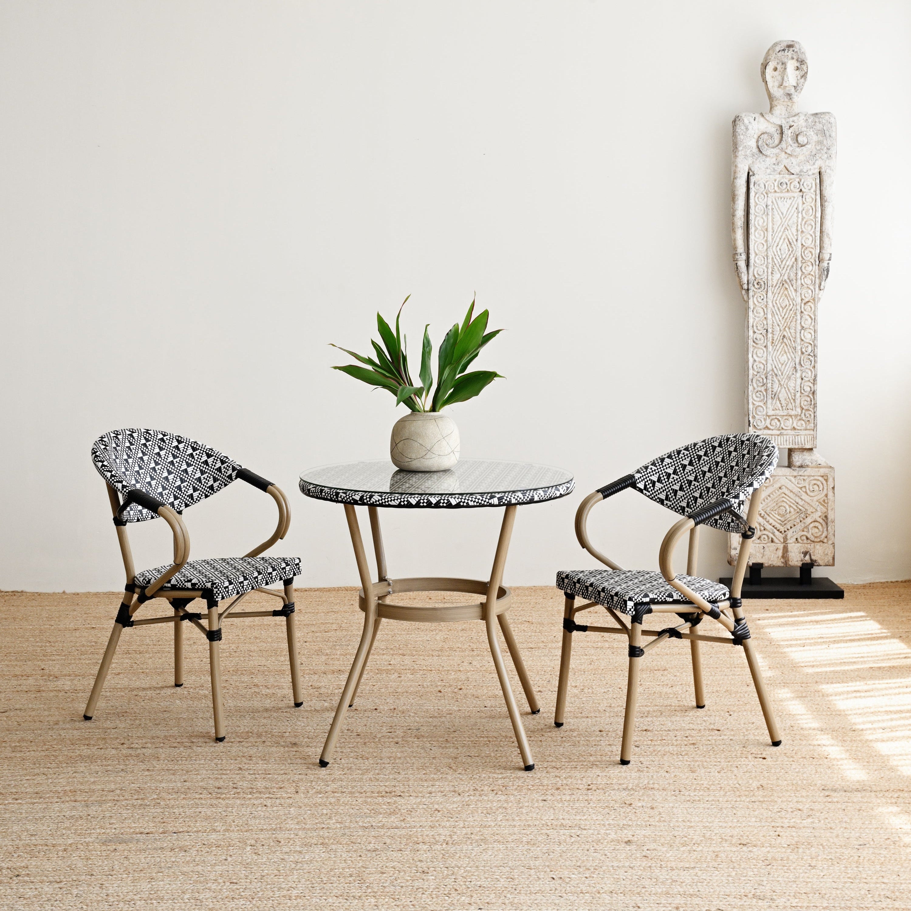Outdoor furniture set with a table and two chairs on a wooden floor.