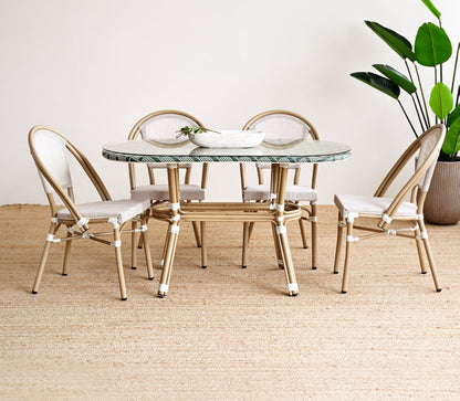 Dining table with chairs in a room with a plant