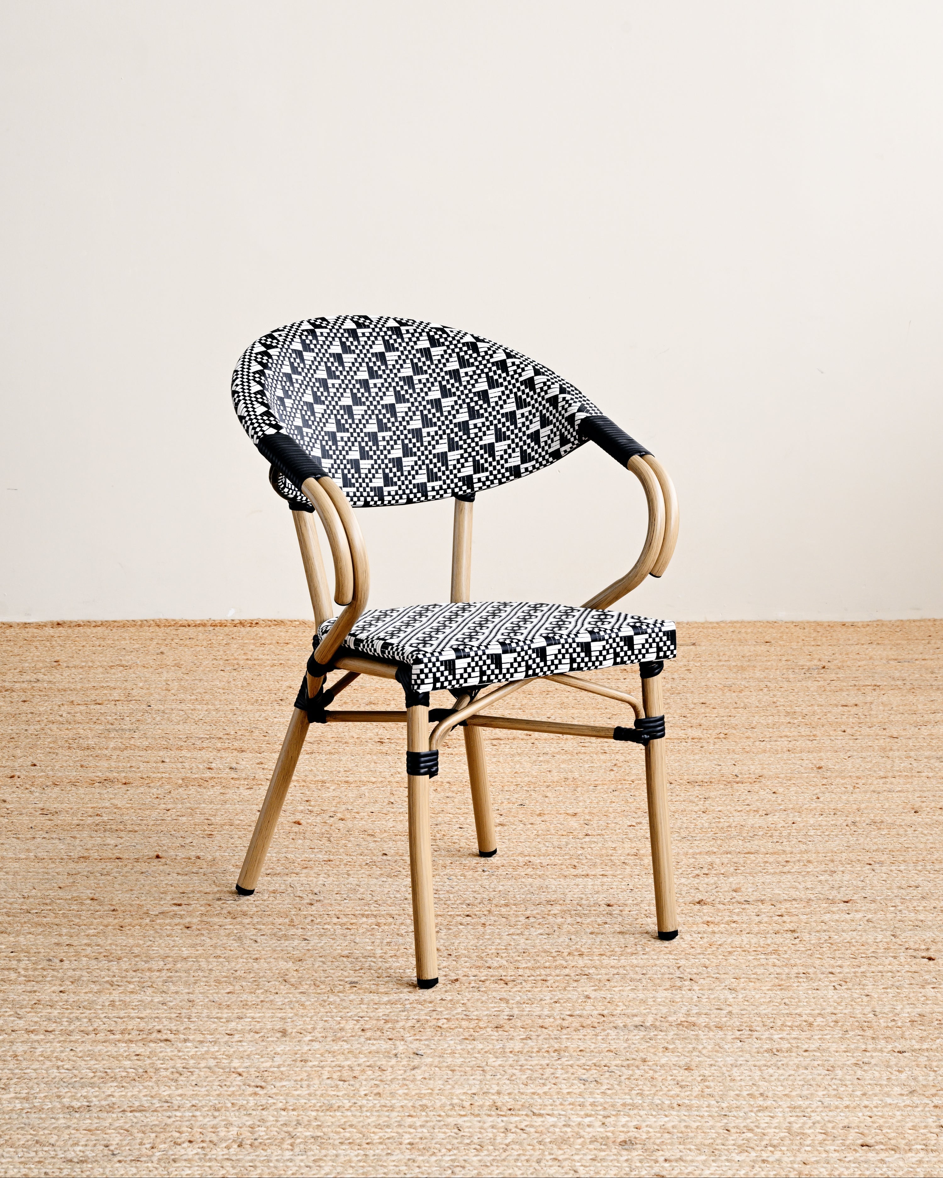 Chair with black and white patterned seat and backrest on a beige background