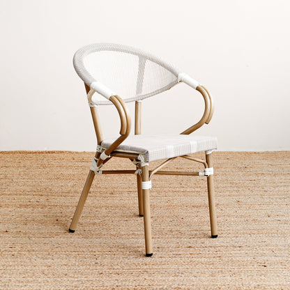 Modern chair with white seat and backrest on a beige floor.