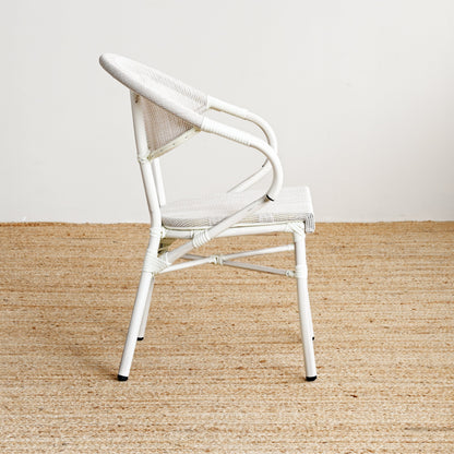 White chair on a beige carpet with a white wall background
