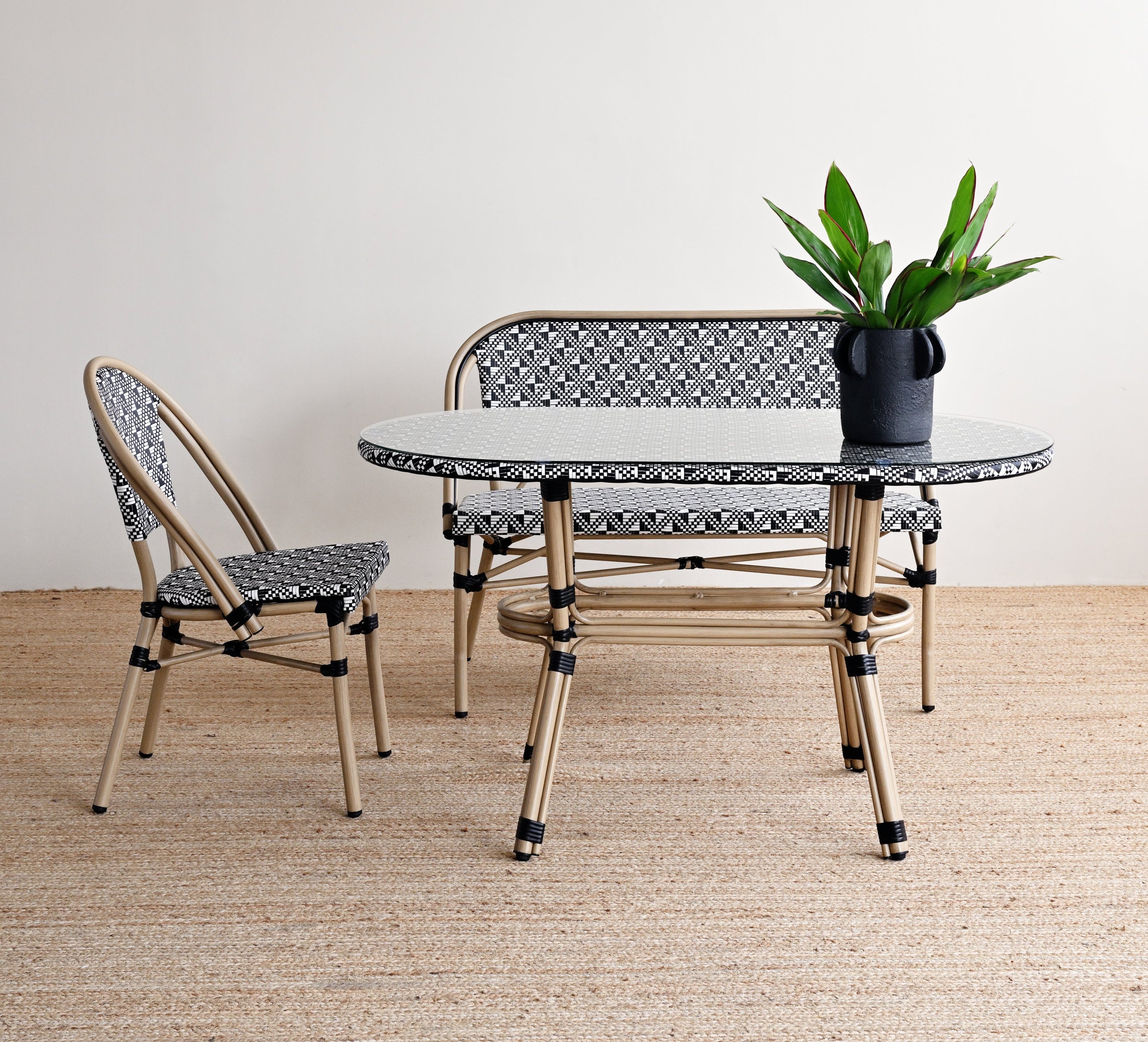Modern outdoor furniture set with a table and two chairs on a wooden floor.