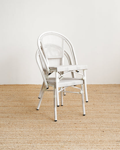 White chair on a beige carpet with a white wall background