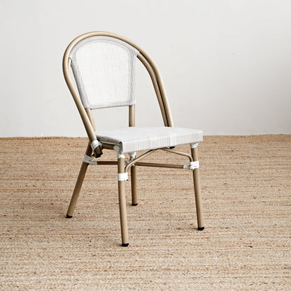 Beige metal chair with white cushion on a beige carpet
