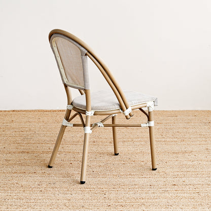 Beige chair with woven backrest on a beige carpet