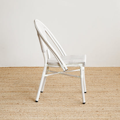 White chair on a beige carpet with a white wall background