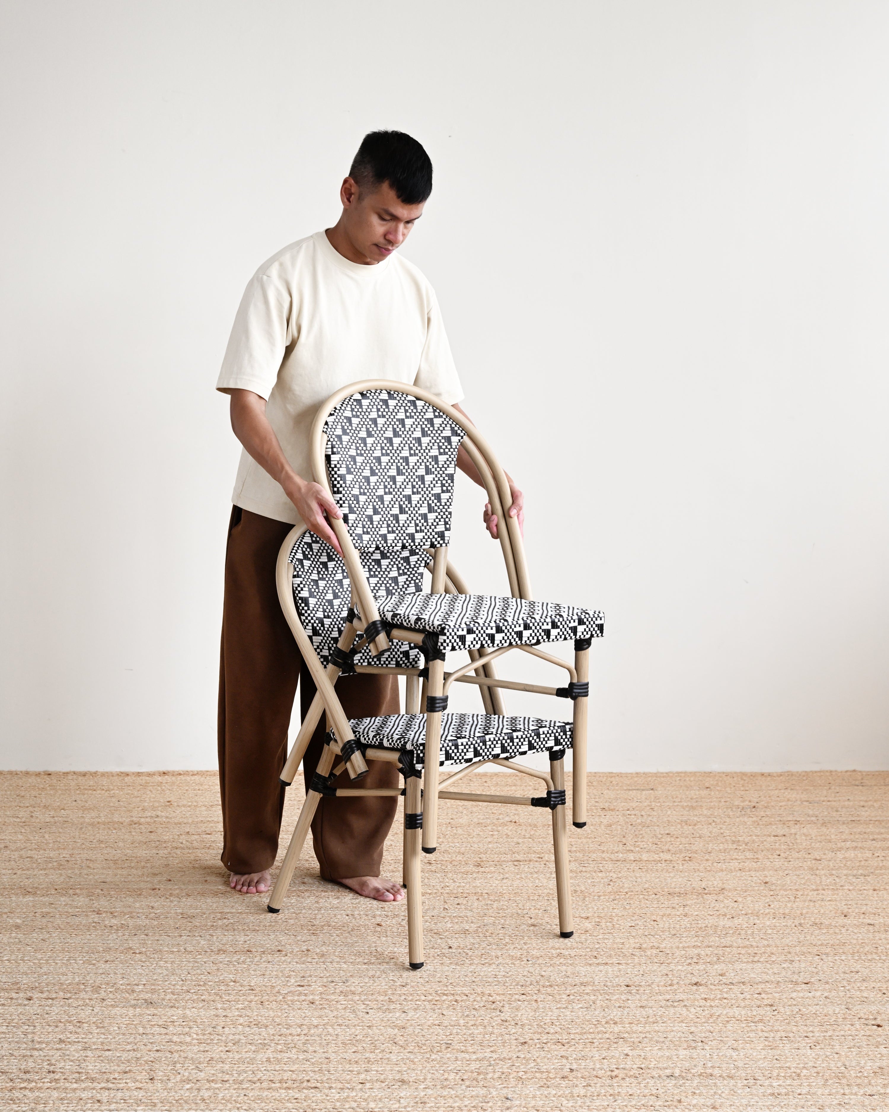 Person assembling a chair with patterned fabric in a minimalistic setting