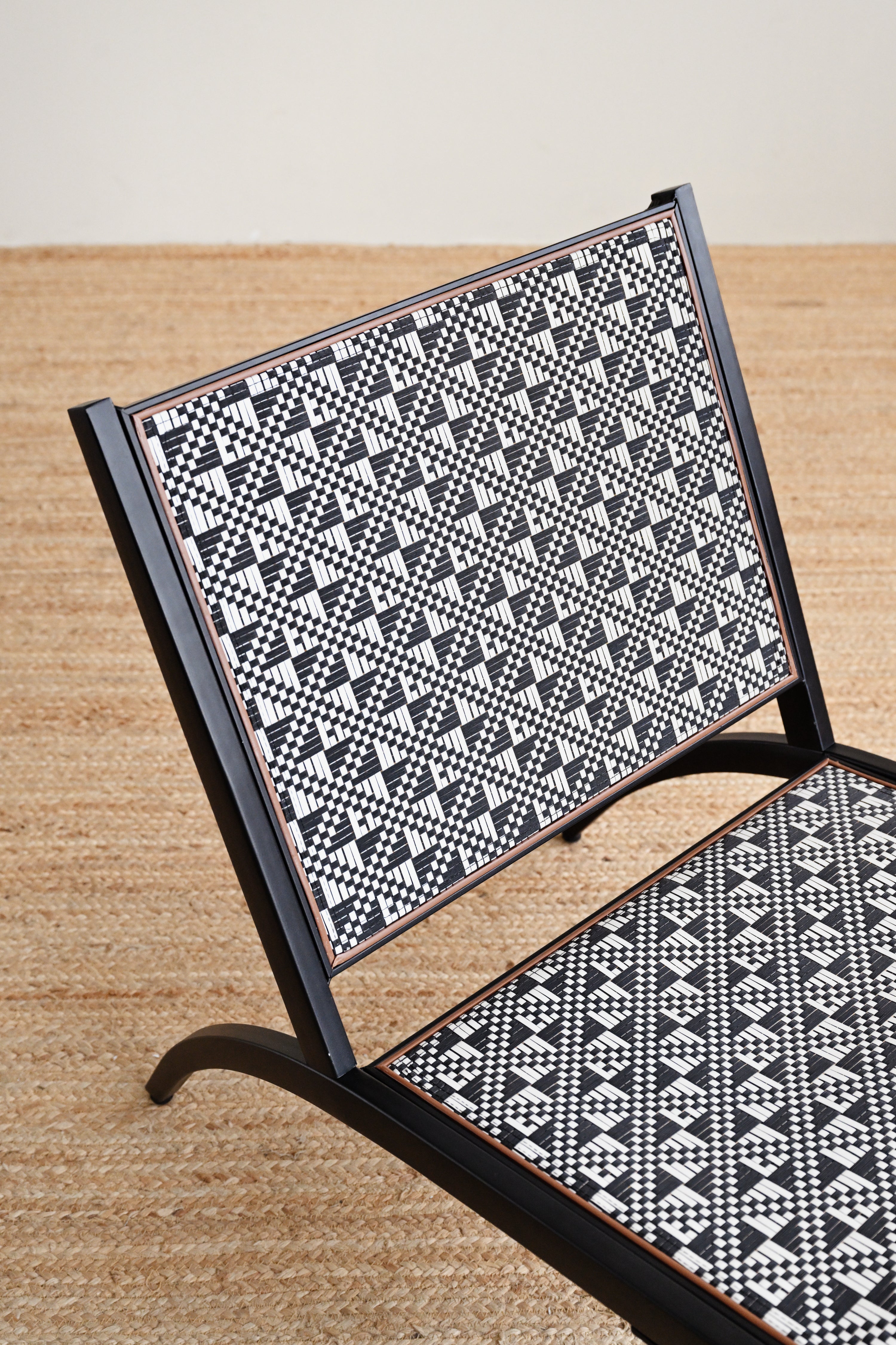 Chair with black and white geometric pattern on a wooden floor