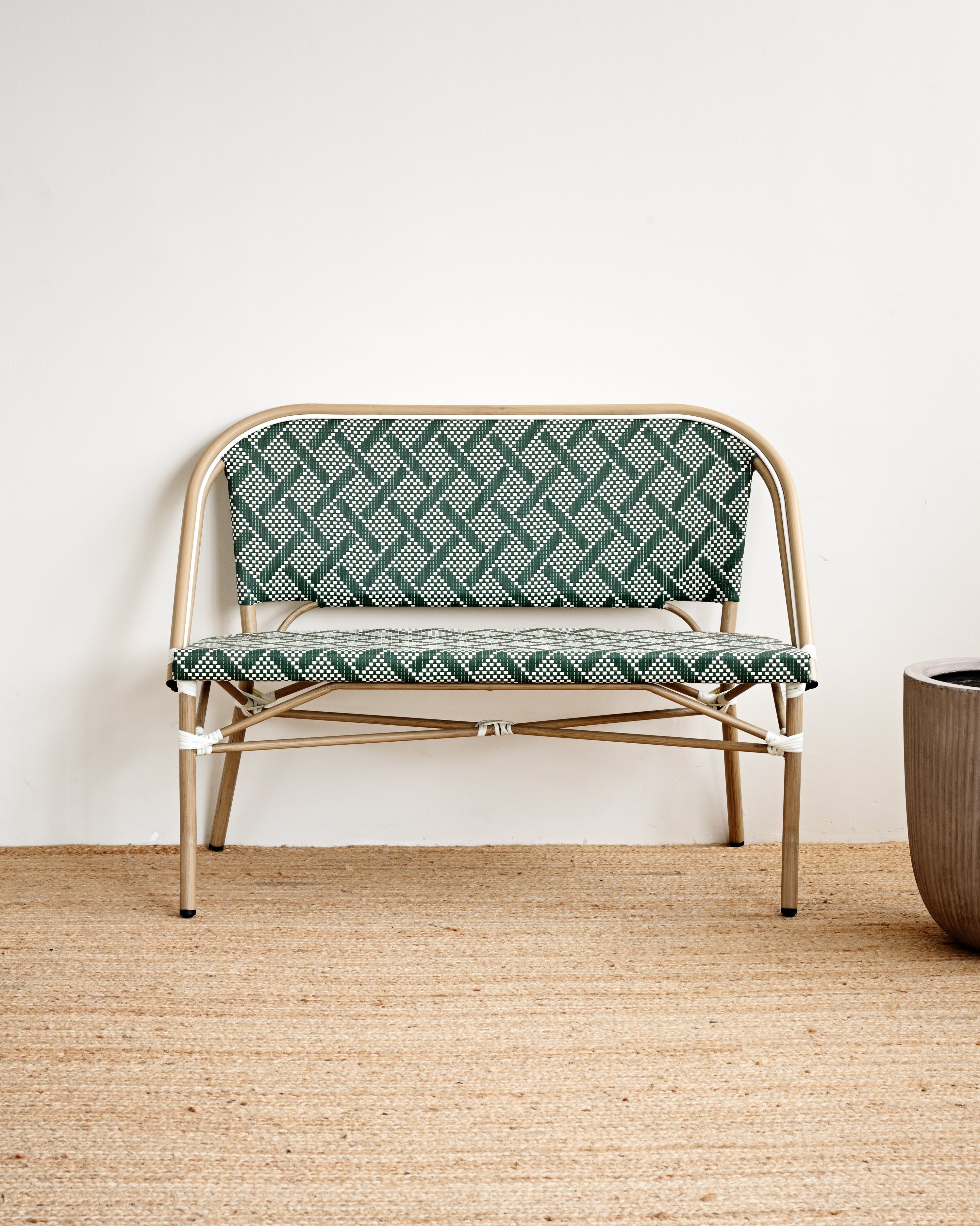 Modern chair with geometric patterned seat and backrest on a wooden floor.