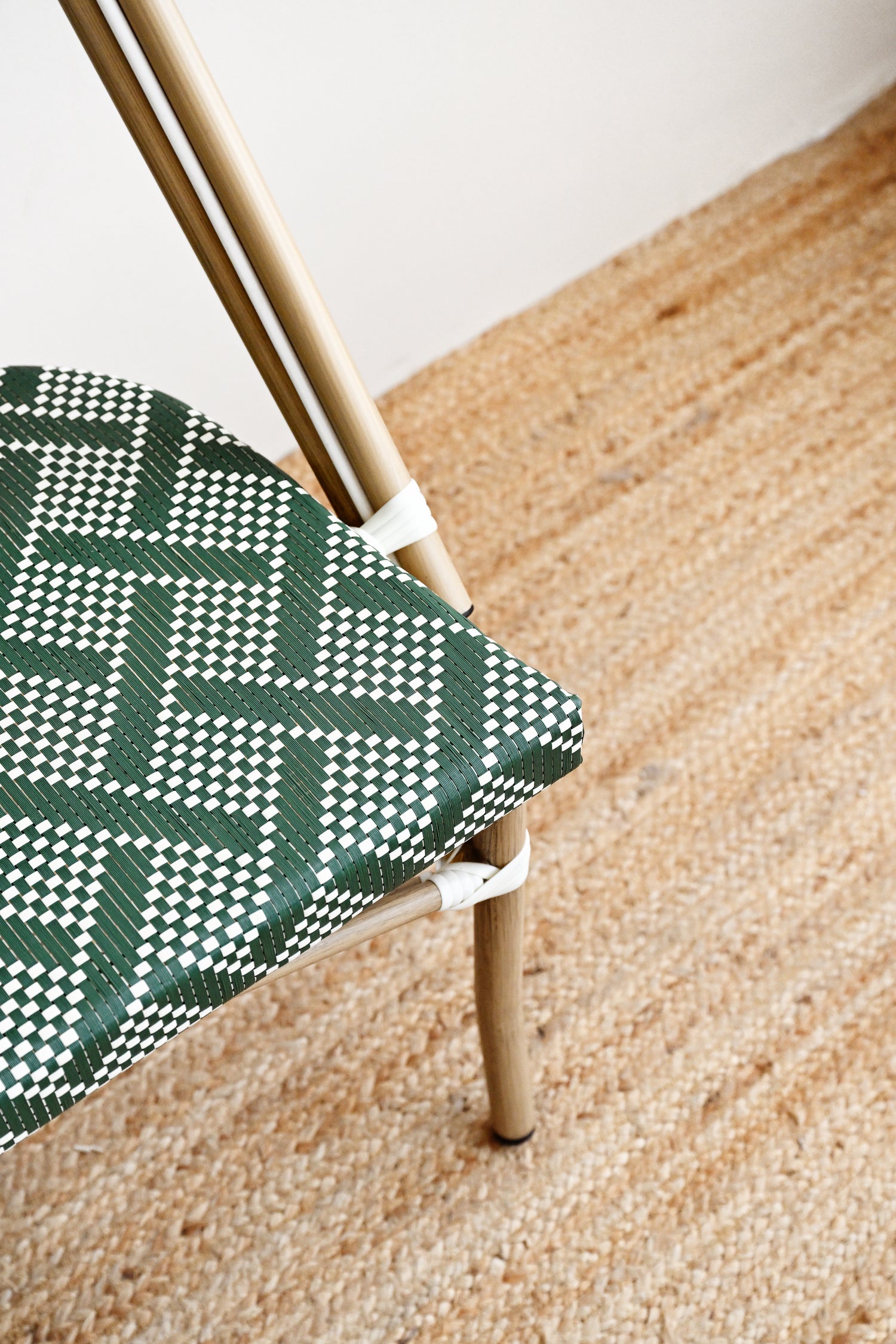 Chair with green and white patterned seat on a wooden floor