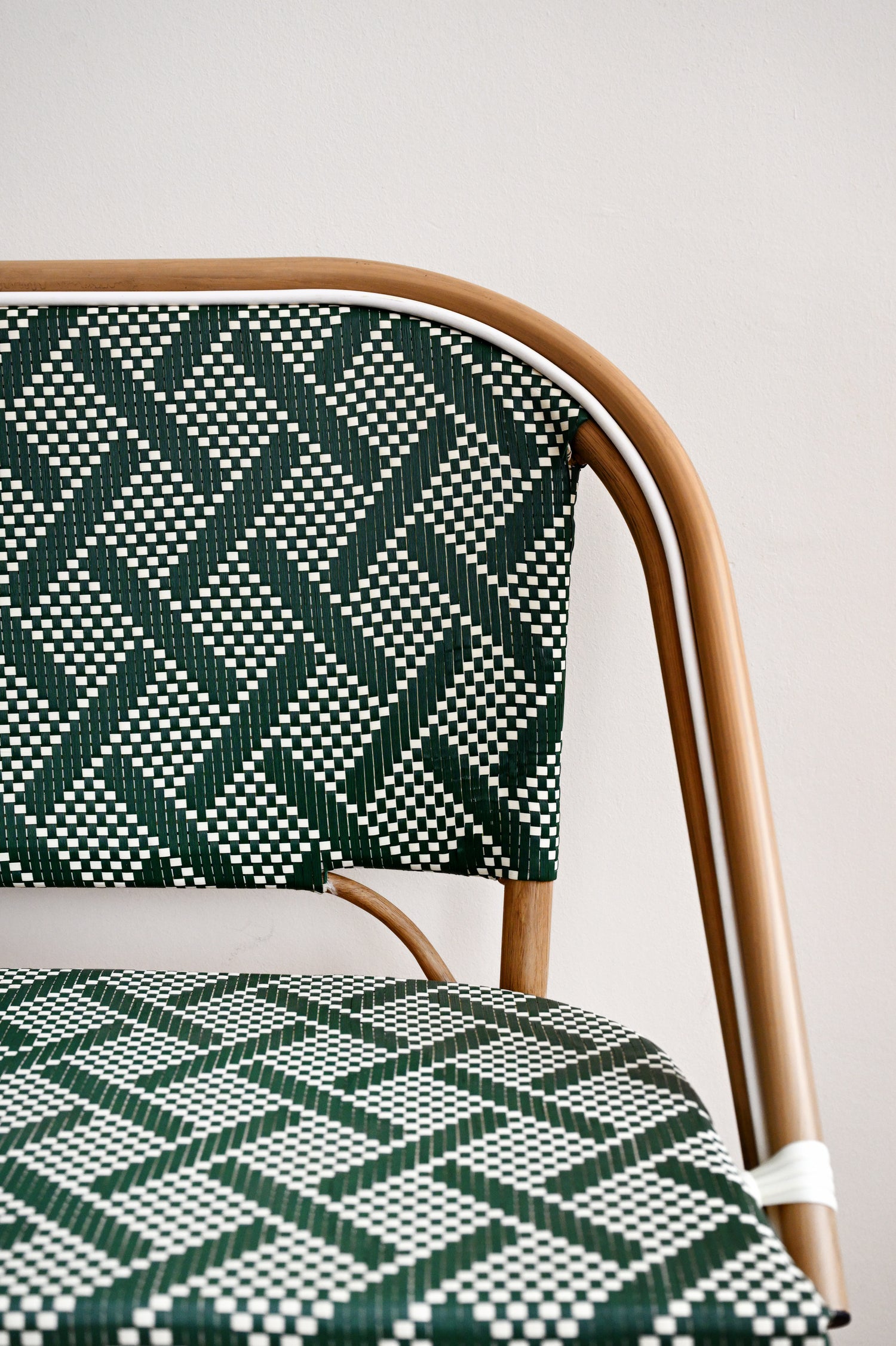 Chair with a green and white geometric pattern on a plain background