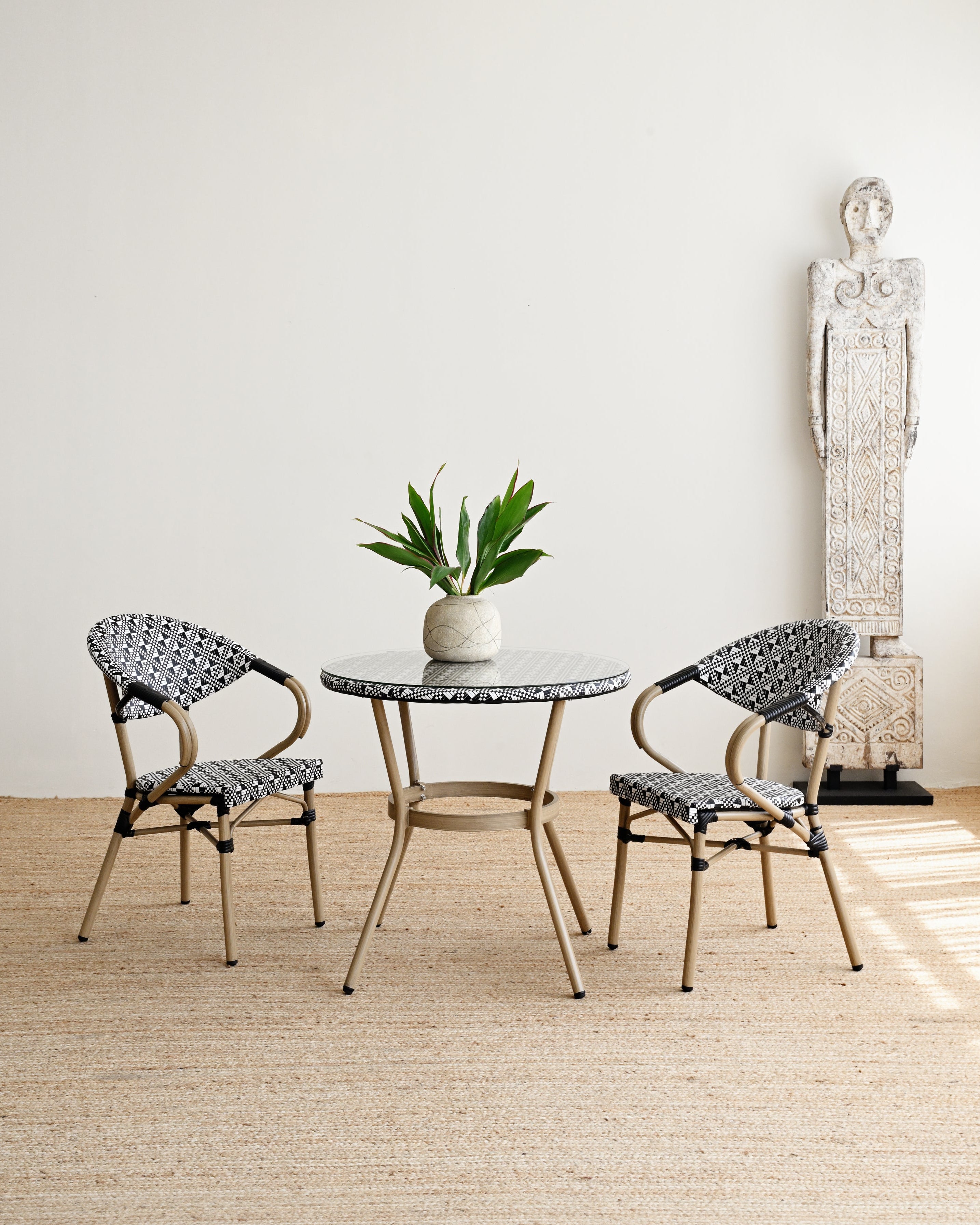 Outdoor furniture set with a table and two chairs on a wooden floor.