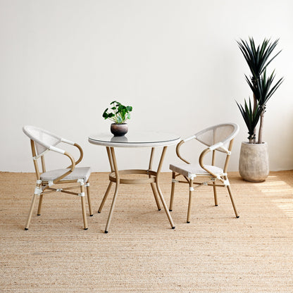 Modern dining set with round table and chairs in a minimalistic room.