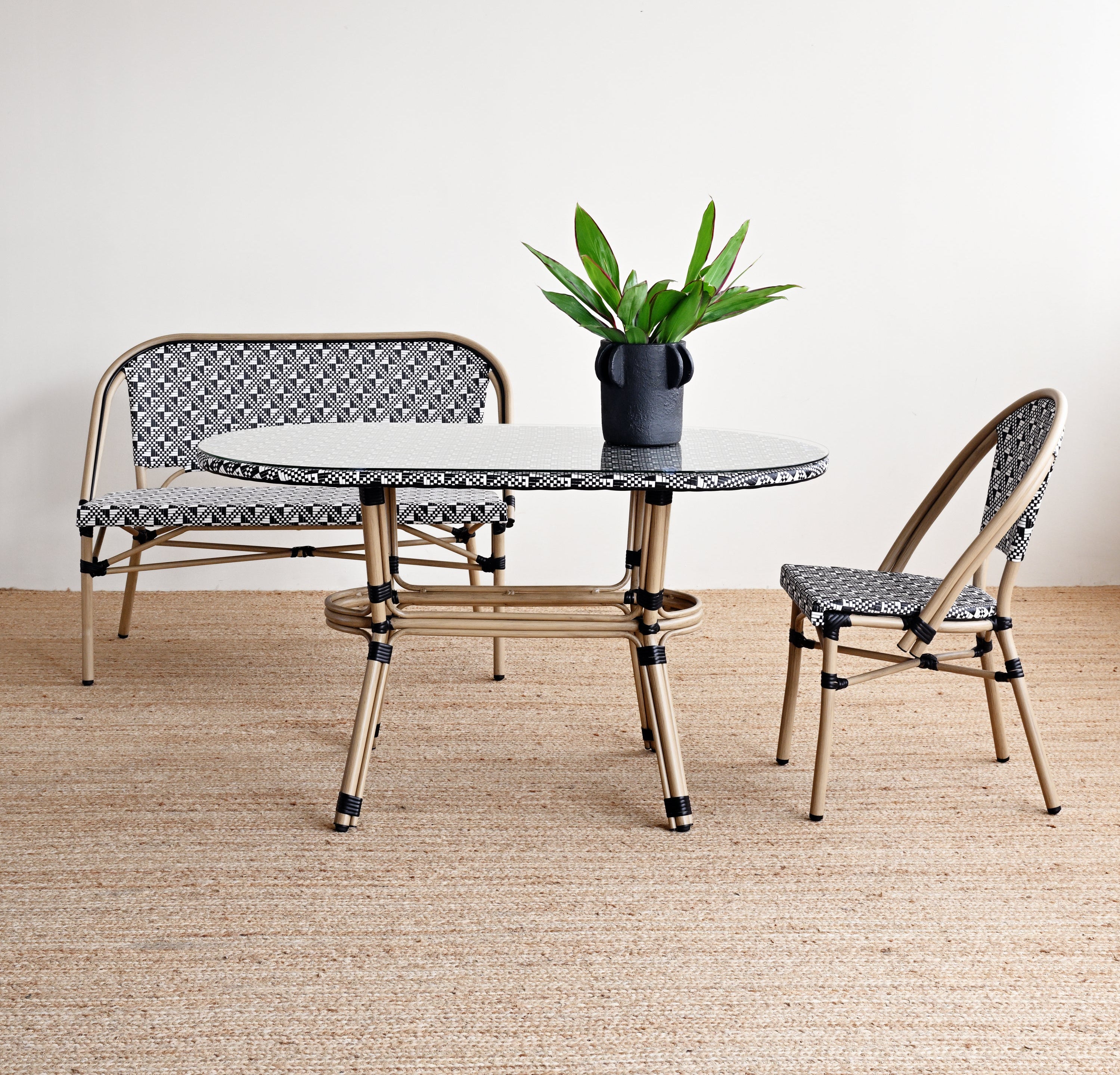 Outdoor furniture set with a table and two chairs on a wooden floor.