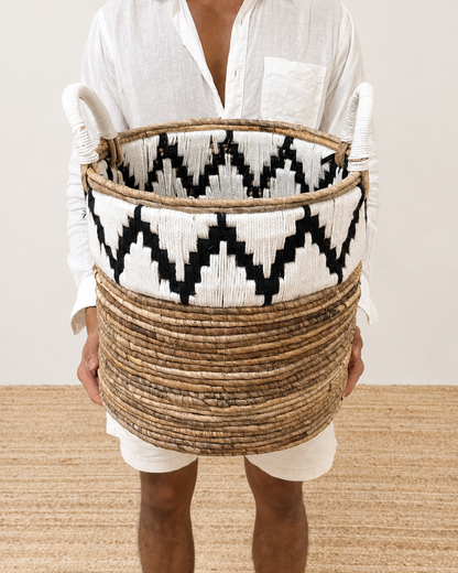 Person holding a woven basket with geometric pattern