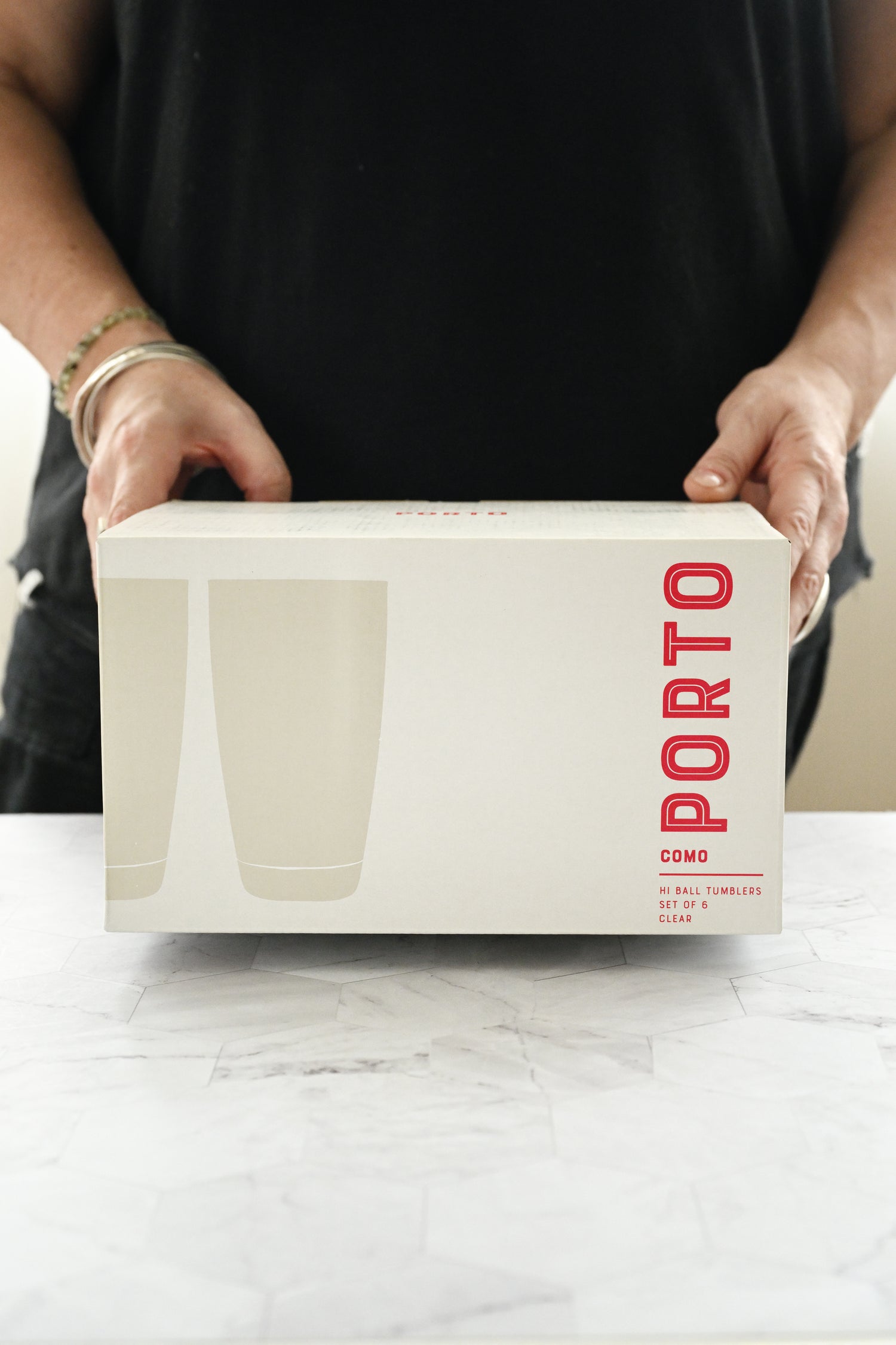 Person holding a white box with &