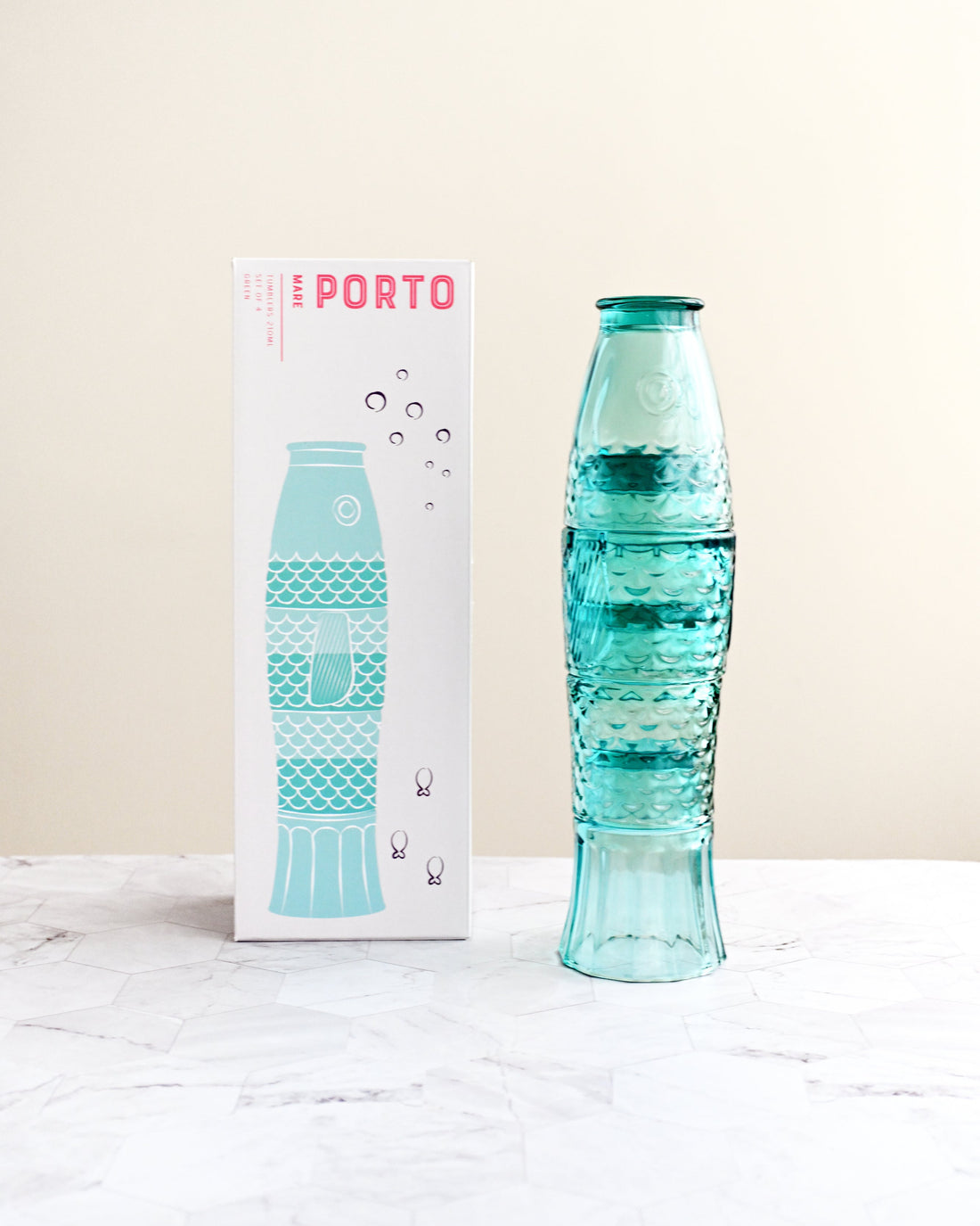 Turquoise water bottle with packaging on a white surface