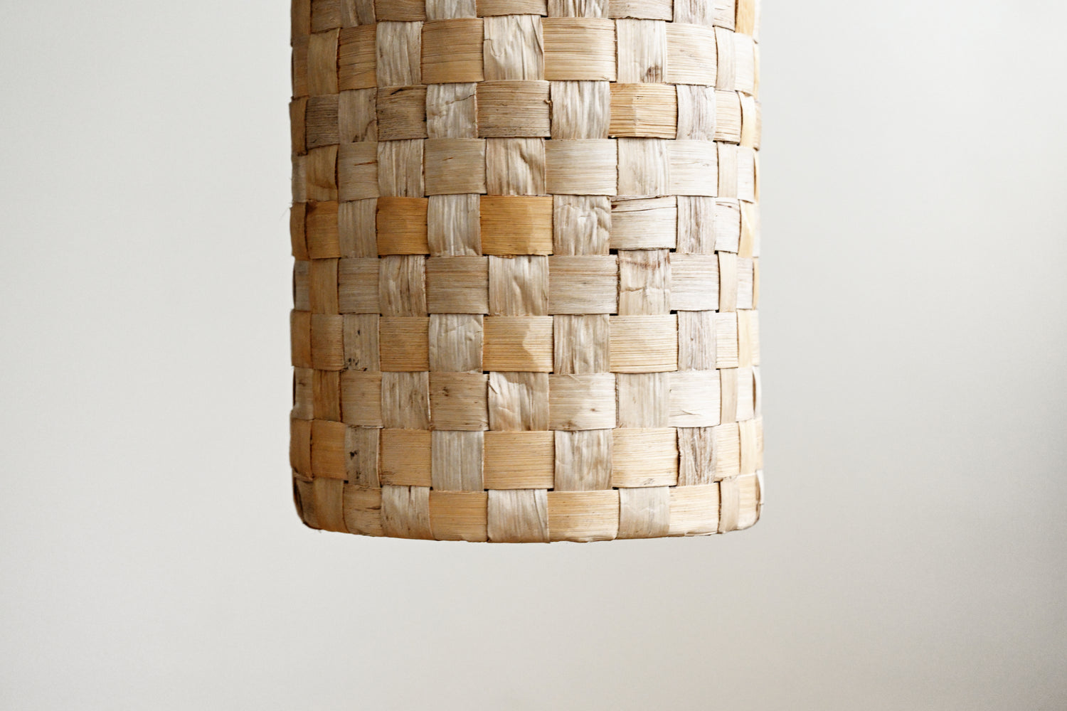 Woven basket with a textured pattern on a plain background