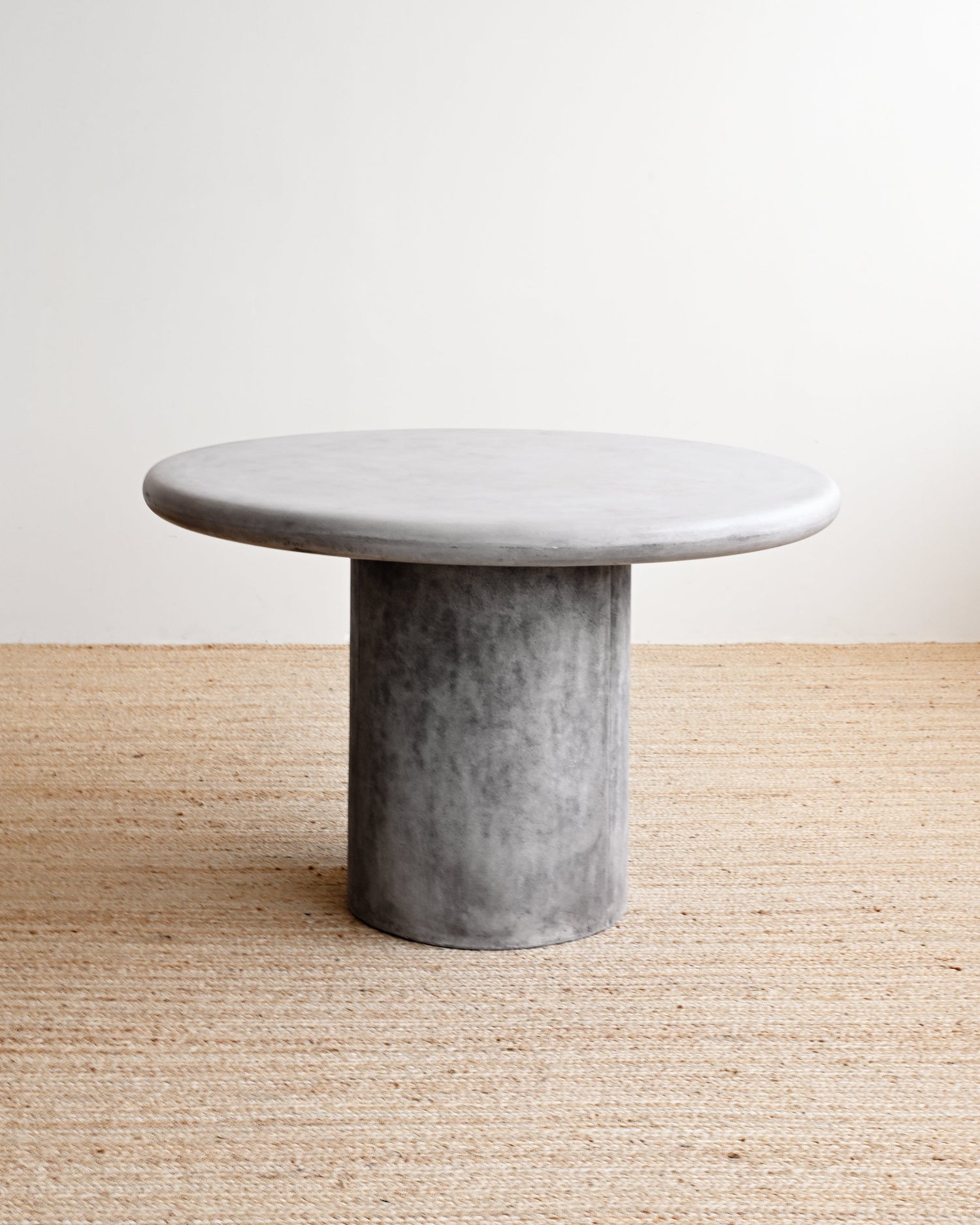 Concrete table on a wooden floor with a white background