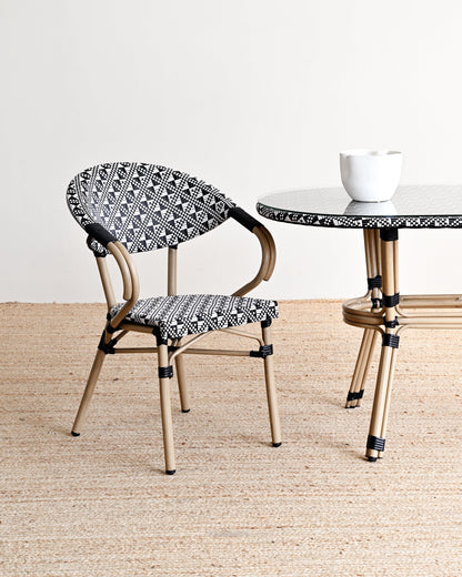 Chair and table with black and white patterned seats and legs on a neutral background