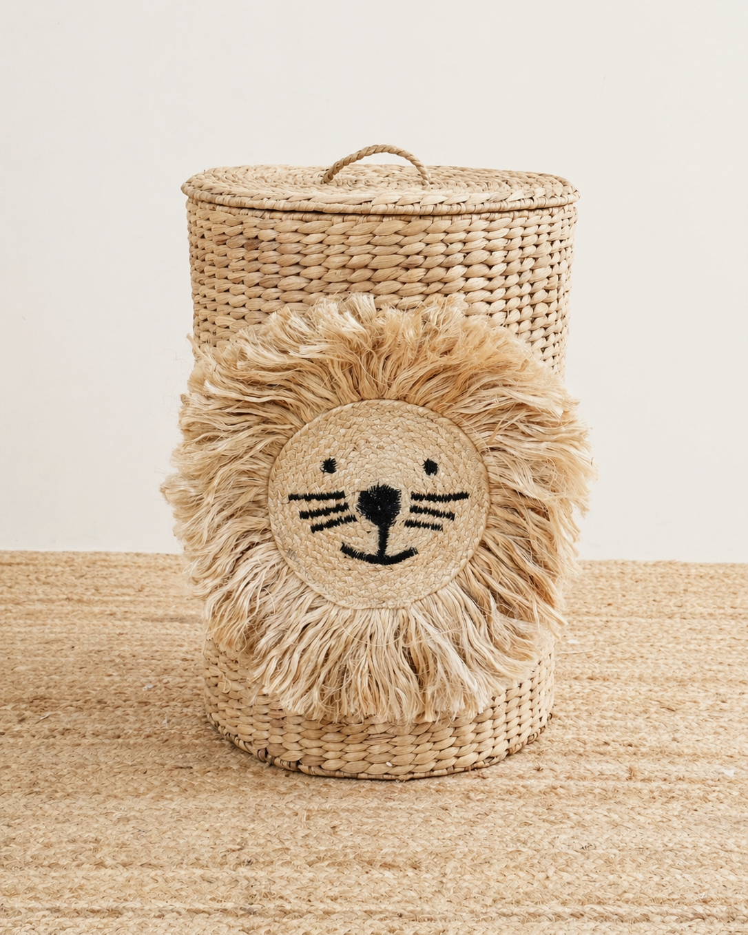 Woven lion-shaped basket with a face design on a textured surface.