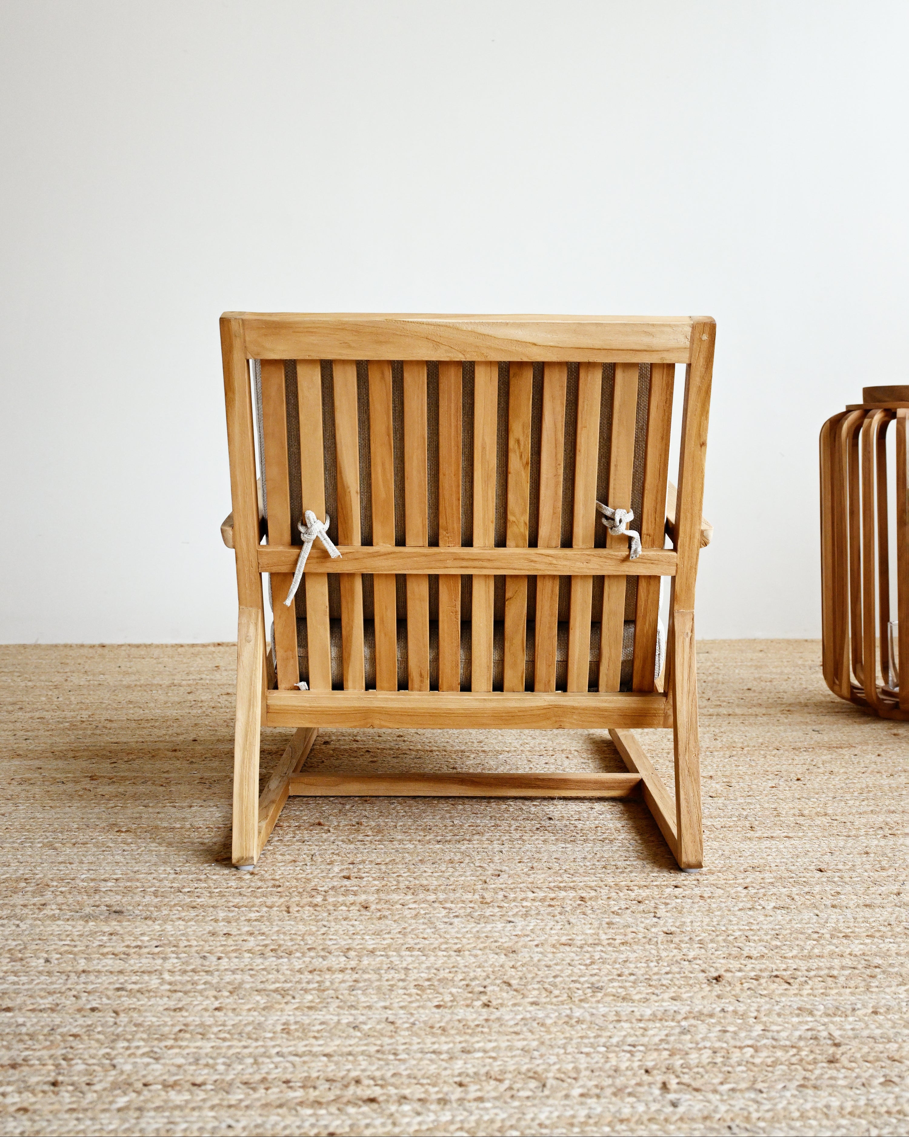 Wooden chair on a textured floor with a neutral background